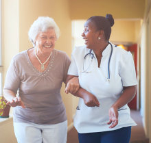 nurse and senior woman smiling