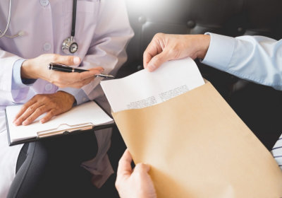 patient handling out her medical record to a doctor